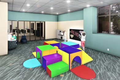 a multi-colored block structure and a blackboard labeled "READ" in a modern room.