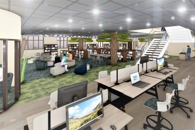workspace with computers, bookshelves, seating areas, and tree-like structures